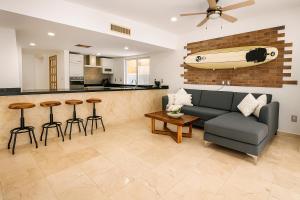 a living room with a couch and a bar at 7BR Private Jacuzzi & Pool Villa Sleeps 16 Walk to Beach Lagoon and Golf in Puerto Aventuras
