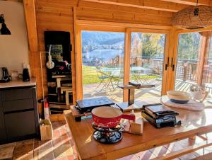 a kitchen with a table and a view of a patio at Chalet Camomille in Les Gets