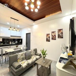 a living room with a couch and a kitchen at CJ Apartments-III in Olongapo