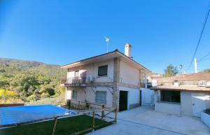 a house with a swimming pool in front of it at El Salón de Arriba in El Real de San Vicente