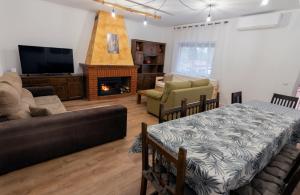 a living room with a couch and a fireplace at El Salón de Arriba in El Real de San Vicente