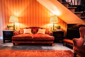 a living room with a couch and two chairs at The Citadel in Weston