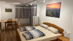 a bedroom with two beds and a table and a table at Mellau Appartments 220 in Mellau