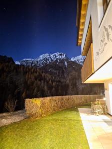 a house with a view of a mountain at ALMRESIDENZ UNTERRAIN -1 km BY CAR DISTANCE SKI SLOPES KRONPLATZ in Valdaora