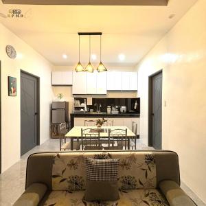 a living room and kitchen with a couch and a table at CJ Apartments-III in Olongapo
