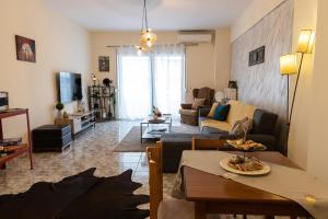 a living room with a couch and a table at Comfort Zone - Spacious Apartment in Xanthi in Xanthi