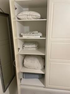 a closet with pillows on shelves in a room at Tilava kaksio saunalla in Seinäjoki