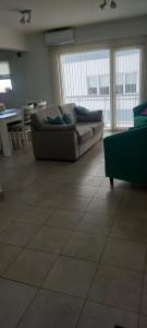 a living room with a couch and a table at Departamento Pepper in Trelew +2 photos