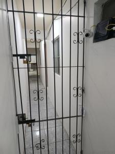 an iron gate with a hallway in a building at Suite COP30 Cozinha e Ar Condicionado Express Centro in Belém