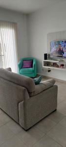 a living room with a couch and a chair at Departamento Pepper in Trelew