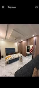 a bedroom with a bed and a couch and a table at Canal road in Faisalabad