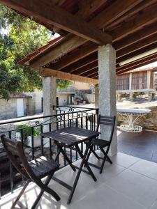 a table and two chairs on a porch with a table and a table at Oak House in São João do Monte