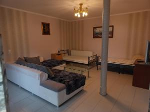 a living room with a couch and a table at "Fürstenhaus-1" 2-ZKB, EG, Terrasse, Hofgeismar-Zentrum! in Hofgeismar