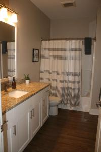 a bathroom with a sink and a toilet and a shower at Modern 2BR & 2BA Condo with Garage & Patio in Grandville
