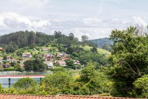 a village on a hill with a river and a bridge at Etxea iradi in Elejalde