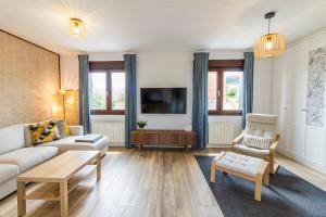 a living room with a couch and a tv at Etxea iradi in Elejalde