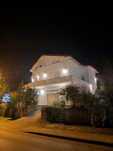 a large white house with lights on it at night at Apartman Mr Guest Krapina in Krapina