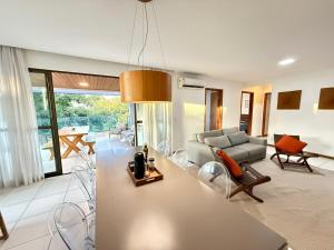 a living room with a couch and a table at Cobertura 3Q ILOA Barra de S Miguel Castelo B Temporada in Barra de São Miguel