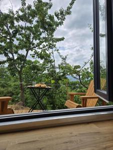 a window view of a table and a tree at In the Wild Volcano Sea Side 