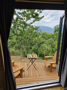 a view of a deck with a table and bench at In the Wild Volcano Sea Side 