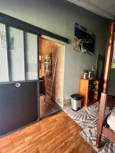 a room with a door open to a living room at Villa Saphir B & B in Sainte-Anne