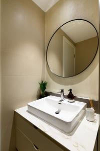 a bathroom with a white sink and a mirror at inJoy in Belgrade +18 photos