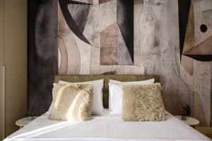 a bedroom with a bed with white sheets and pillows at inJoy in Belgrade