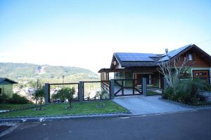 a house with a solar panel on the roof at Casa Petri Gramado casa inteira para 7 pessoas ideal para famílias in Gramado