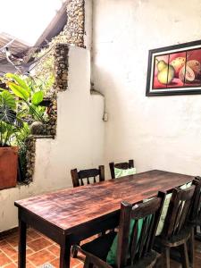 a wooden table and chairs in a room at Sandalio Hostal Cali in Cali