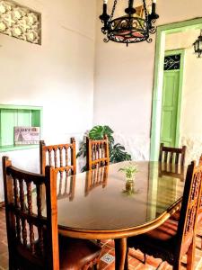a dining room with a table with chairs and a chandelier at Sandalio Hostal Cali in Cali +39 photos