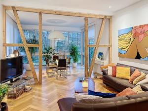 a living room with a couch and a tv at Strasbourg Tivoli in Strasbourg