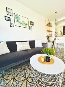 a living room with a couch and a table at SOL Aguadulce in Roquetas de Mar