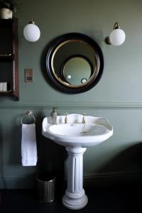 a bathroom with a white sink and a mirror at The Citadel in Weston +19 photos