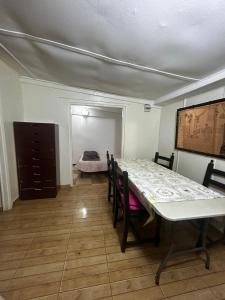 a dining room with a table and chairs and a bedroom at Cabanon pied sur mer in Mohammedia