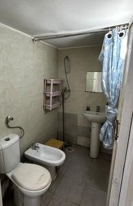 a bathroom with a toilet and a sink at Cabanon pied sur mer in Mohammedia
