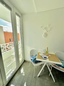 a dining room with a table and chairs and a window at AMBER APARTMENTS - SUNNY STUDIO in Morro del Jable +31 photos
