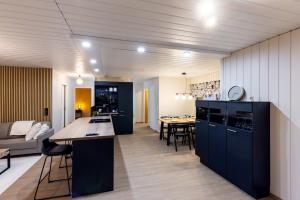a kitchen and living room with a couch and a table at Teddy's Hideout in Rovaniemi +11 photos