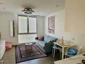 a living room with a couch and a table at AMBER APARTMENTS - PINK STUDIO in Morro del Jable