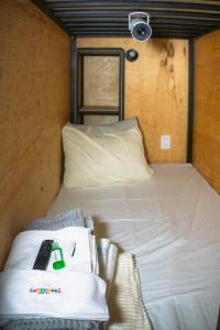 a bed in a room with a remote control on it at Hostal KEMMM in Mexico City