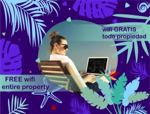 una mujer sentada en una silla con una computadora portátil en Nice condo with fresh pool, en Punta Cana