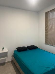 a bedroom with a bed with two pillows on it at Departamento en malecon acogedor in San Bartolo
