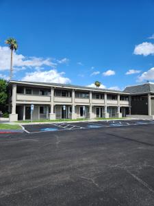 an empty parking lot in front of a building at Travelodge by Wyndham Phoenix North in Phoenix