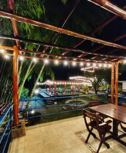 a patio with a table and a view of the water at Finca privada de lujo Casalegre in Pance +17 photos