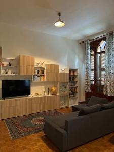 a living room with a couch and a flat screen tv at Castello di Fiorano in Piacenza