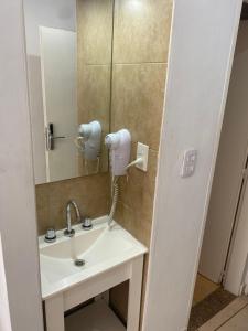 a bathroom with a sink and a mirror at Appart Tucuman in Buenos Aires +23 photos