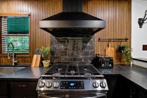 a kitchen with a stove top oven in a kitchen at Tranquil Hocking Hills Cabin For 8-Hot Tub Games in South Bloomingville