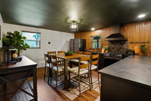 a kitchen with a table with chairs and a stove at Tranquil Hocking Hills Cabin For 8-Hot Tub Games in South Bloomingville