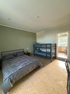 a bedroom with a bed and a bunk bed and a window at Grand Tour - Cascata delle Marmore in Le Marmore
