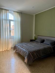 a bedroom with a large bed and a large window at Grand Tour - Cascata delle Marmore in Le Marmore