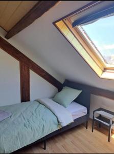 a bedroom with a bed and skylights in the ceiling at Colocation in Trignac